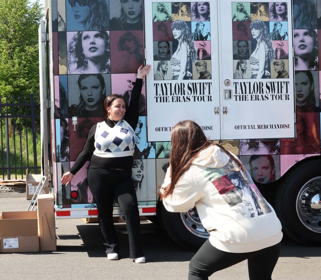Bella Pelletiere of Mansfield poses for a photograph next to a  Taylor Swift merchandise trailer outside Gillette Stadium on Thursday, May 18, 2023.