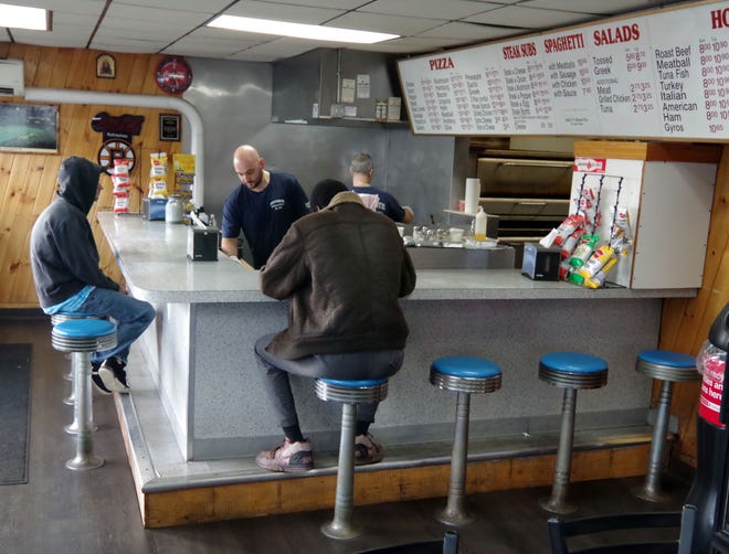 Inside the Supreme Pizza House of Pizza in Brockton on Tuesday, Nov. 14, 2023, a friendly, comfortable, neighborhood restaurant, and that's just the way the customers like it.
