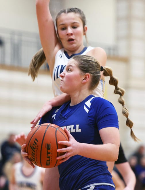 Norwell's Reagan Dowd scores a basket past East Bridgewater defender Jenna Oman during a game on Friday, Jan. 5, 2024.