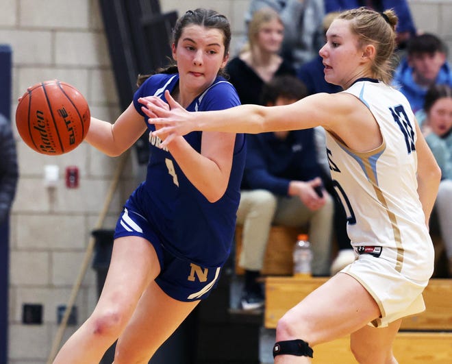 Norwell's Alex Cassidy attempts to dribble around East Bridgewater defender Lily Pavidis during a game on Friday, Jan. 5, 2024.