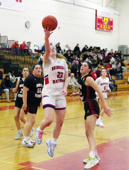 Bridgewater-Raynham's Reese Bartlett cuts through the North Quincy defense to hit a shot to increase the Trojan lead in the 1st half of the game on Monday, Jan. 8, 2024.