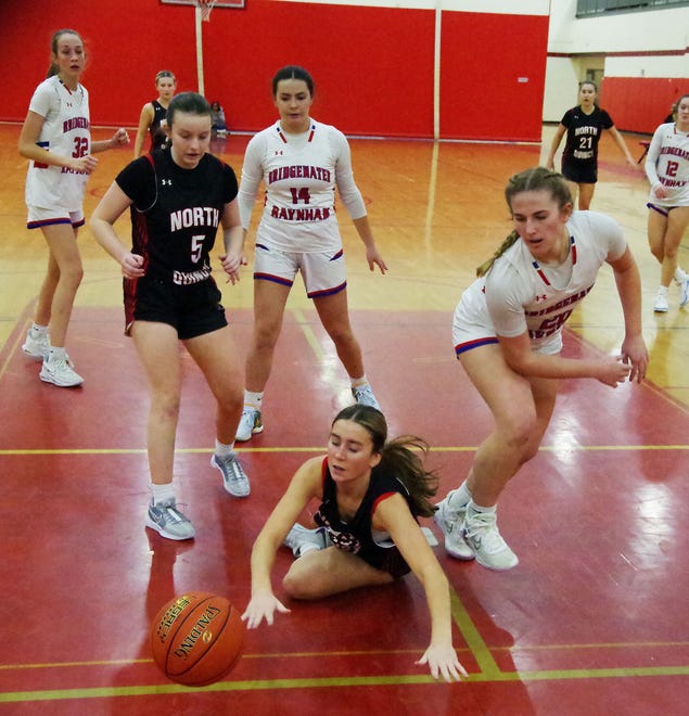 Nora Geary of North Quincy hit the deck chasing a loose ball, while teammate Meaghan Smith #5, Bridgewater-Raynham's Olivia Roy and Ally Piecewicz look on during the game on Monday, Jan. 8, 2024.