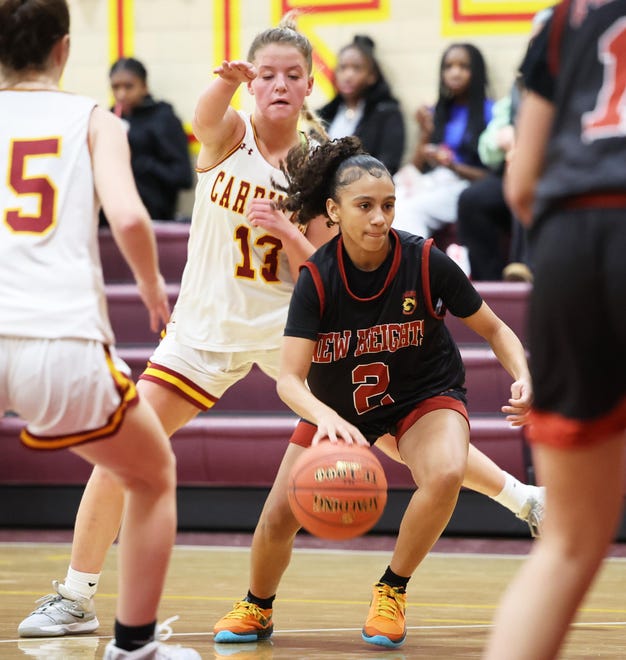 New Heights Jay 'laDepina dribbles around Cardinal Spellman defender Erin O'Donnell during a game on Tuesday, Jan. 9, 2024.