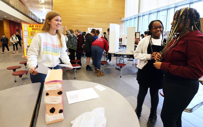 Teacher Jillian Blye, left,  with  Ony Agmooh, 12, and Abbygail Chervil, 12, speak about their project 'Bubonic Plaque' during West Bridgewater Middle- Senior High School National History Day on Wednesday, Jan. 10, 2024. National History Day allows seventh grade students to not only study and learn about a topic that is interesting to them, but also to express their interest in creative ways. Matt Despier is the seventh grade social studies teacher.