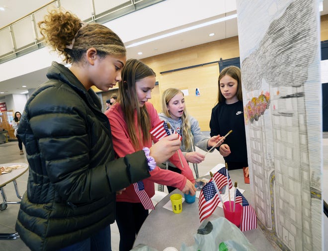 From left, Kayla Walker, 12, Chloe George, 13, Chloe Concannon, 13, and Leah Perez, 12, with their project '911' during West Bridgewater Middle-Senior High School National History Day on Wednesday, Jan. 10, 2024. National History Day allows seventh grade students to not only study and learn about a topic that is interesting to them, but also to express their interest in creative ways. Matt Despier is the seventh grade social studies teacher.