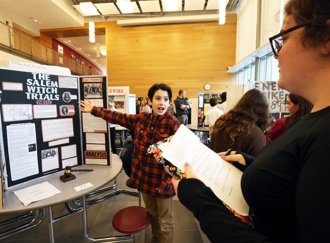 Kam Martin, 12, explains his 'Salem Witch Trials' project to teacher Emma Preston during West Bridgewater Middle-Senior High School National History Day on Wednesday, Jan. 10, 2024. National History Day allows seventh grade students to not only study and learn about a topic that is interesting to them, but also to express their interest in creative ways. Matt Despier is the seventh grade social studies teacher.
