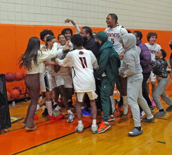 The Avon Panthers varsity basketball team celebrates after winning a 72-20 OT thriller against rival Holbrook on Wednesday, Jan. 10, 2024, on a last-second winning shot by Josiah Guerrier.