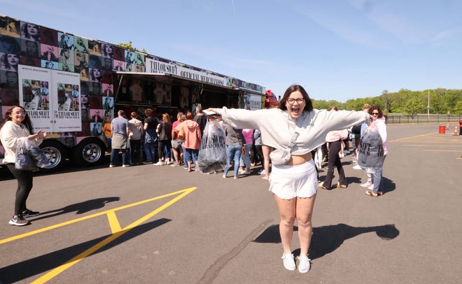 Elizabeth Michaud of Lewiston, Maine holds a shirt as thousands of Taylor Swift fans line up to purchase merchandise outside Gillette Stadium on Thursday, May 18, 2023.