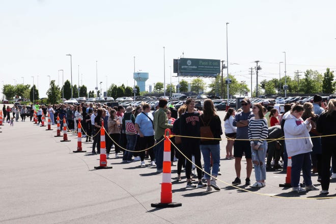 Thousands of Taylor Swift fans line up to purchase merchandise outside Gillette Stadium on Thursday, May 18, 2023.